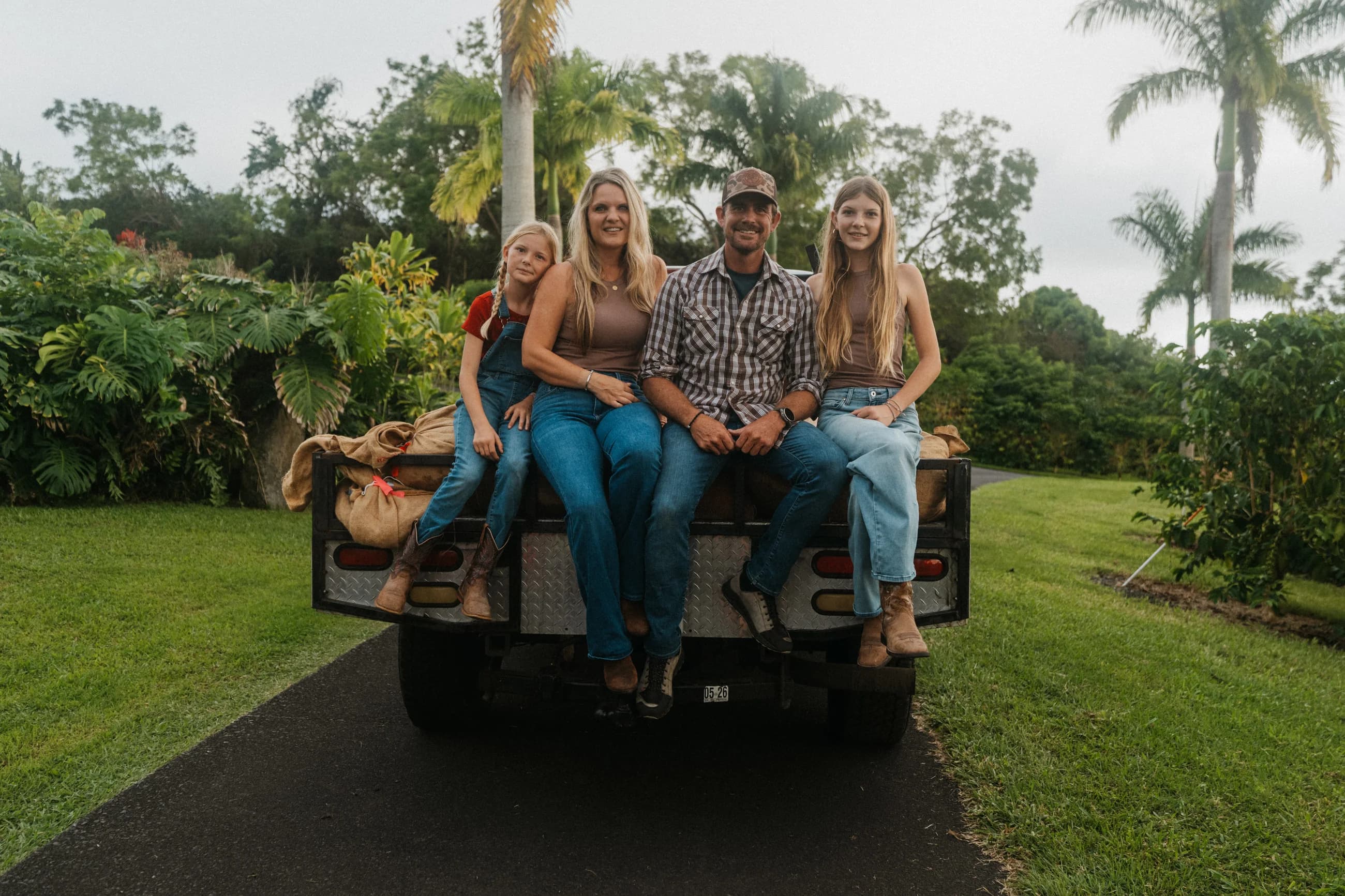 Tyler and Diandra Dickinson with their daughters Olivia and Peyton on the farm truck